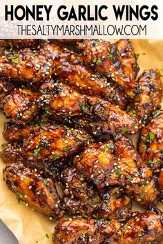 honey garlic wings with sesame seeds on top and the words honey garlic wings above it