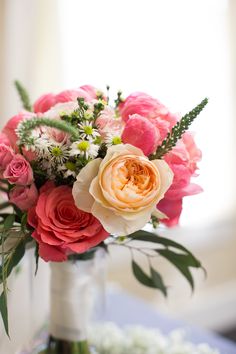 a vase filled with pink and white flowers