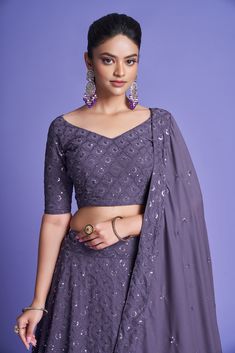 Make a statement in this 3-piece Mauve Purple Diamond Georgette Thread & Sequins Embroidered Lehenga Choli Set, featuring a floor-length lehenga with 4 meters of flair, a Sweetheart Neck blouse, and a 2.30-meter Dupatta. The no-fuss outfit comes semi-stitched with a standard cancan and canvas attached; plus, customizations are available upon request. Dry Clean only and rock on, fashionista! No of Set - 3-piece set Color- Mauve Purple Blouse Fabric - Diamond Georgette Blouse Sleeves-Regular Sleev Georgette Lengha, Engagement Saree, Traditional Festival, Salwar Dress, Dress Salwar Kameez, Blouse Measurement, Embroidered Lehenga, Mauve Purple, Lehenga Collection