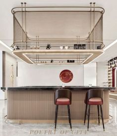 two bar stools sit in front of a counter