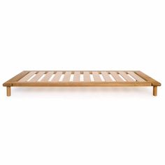 a wooden bed frame sitting on top of a white floor