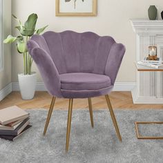 a purple chair sitting on top of a rug in a living room