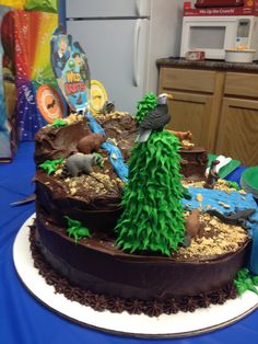 a cake that is sitting on top of a table with blue cloths and decorations