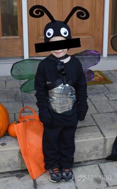 a little boy dressed up as a bug