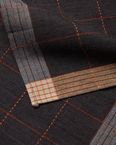 a close up view of a suit with orange and blue pinstripes on it