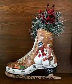 an old boot decorated with christmas decorations and pine cones is sitting on a wooden surface