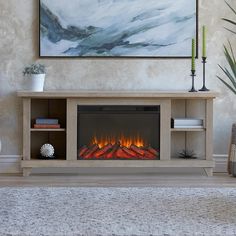 a living room with a large painting on the wall and a fire place in the fireplace