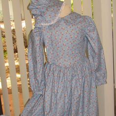 This two piece set will have your Little House fan ready for any dress up occasion.  The outfit consists of a prairie dress and matching sunbonnet - READY TO SHIP - in a Size S(7/8).  The pioneer dress is made in a sweet blue calico cotton, with a wide collar and full length puffed sleeves with cuffs.  The full skirt is hand hemmed so it can easily be let down as your pioneer girl grows.  The dress has a zipper closure at the back.  The sunbonnet is made in the same calico cotton, with a wide, e Pioneer Girl, Pioneer Dress, House Fan, Let Down, Prairie Dress, Puffed Sleeves, Girl Costumes, Full Skirt, Body Measurements