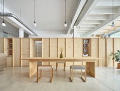 a large wooden table sitting in the middle of a room with lots of bookshelves