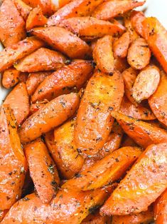 cooked carrots with herbs and seasoning in a white bowl