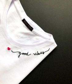 a white t - shirt with the words good vibes written on it