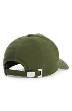 a green hat with metal buckles on the side