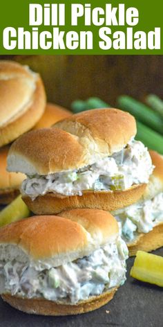 three chicken salad sandwiches stacked on top of each other with green beans in the background