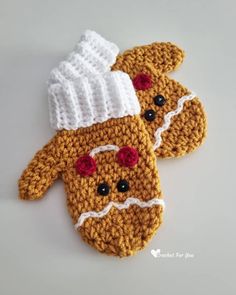 two crocheted mittens are sitting on a table