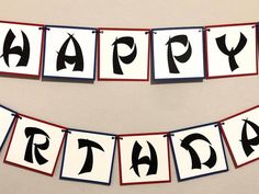 a happy birthday banner hanging on a wall with the words happy birthday spelled in black and red