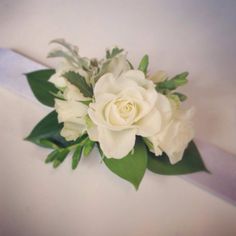 a bouquet of white flowers on top of a table