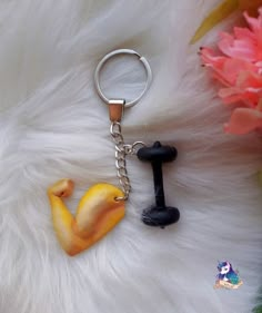 a close up of a key chain on a furry surface