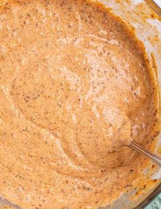 a bowl filled with sauce on top of a table