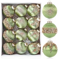 green christmas ornaments in a box with gold glitters on the top and bottom, including one ornament