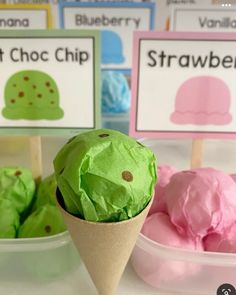 some ice cream cones are sitting on the table