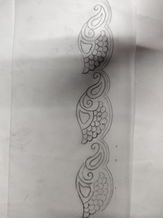 an artistic tattoo design on the side of a white sheet of paper with black ink