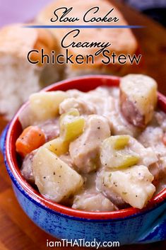 a blue bowl filled with chicken stew next to bread on a wooden table and text overlay that reads slow cooker creamy chicken stew