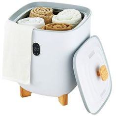 a white cooler with towels and rolls in it