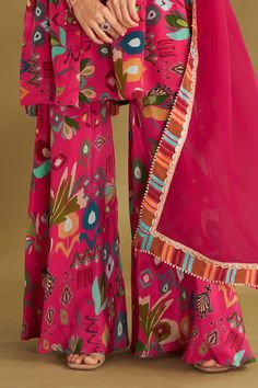 Hot pink gathered short anarkali with ikat, floral print and gold embroidery in front and sleeves. Paired with printed sharara and border printed dupatta. - Aza Fashions Festival Lehenga With Printed Motifs And Straight Kurta, Diwali Anarkali Sharara With Printed Motifs, Chanderi Sharara With Printed Motifs For Festivals, Anarkali Style Festive Palazzo Set With Printed Motifs, Anarkali Sharara With Printed Motifs For Diwali, Diwali Maxi Sets With Printed Motifs, Anarkali Palazzo Set With Printed Motifs For Festive Occasions, Diwali Maxi Length Sets With Printed Motifs, Festive Chanderi Sharara With Printed Motifs