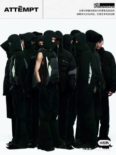 a group of men in hooded clothing standing next to each other with their backs turned