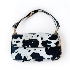 Introducing our Cowprint Purses – a bold and stylish accessory that adds a touch of playful elegance to your ensemble. These chic purses feature a classic black and white cowprint pattern that's both eye-catching and versatile. Crafted with attention to detail, these purses are designed to complement various outfits and occasions. - 10 x 6 in - Includes gold chain purse strap Black Bag With Cow Print For Everyday Use, Trendy Cow Print Bags For Everyday Use, Chic Black And White Rectangular Shoulder Bag, Chic Black Bag With Zebra Print, Chic Black Bags With Zebra Print, Chic Rectangular Shoulder Bag With Zebra Print, Chic Zebra Print Rectangular Shoulder Bag, Chic Rectangular Zebra Print Shoulder Bag, Trendy Black Zebra Print Bags