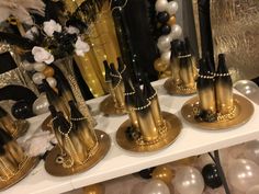 gold and black candlesticks on display in front of balloons