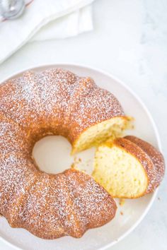 a bundt cake on a white plate with powdered sugar