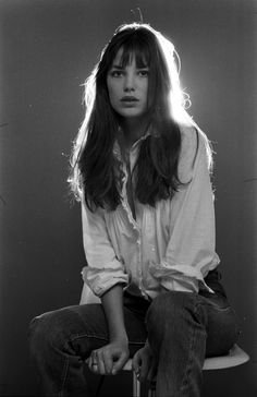 a black and white photo of a woman with long hair