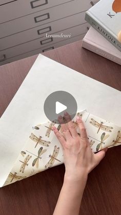 a person is making an origami airplane out of paper