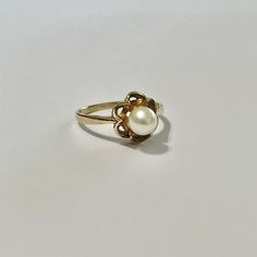 Beautiful vintage 10k yellow gold cultured pearl ring! This classic piece features a beautiful cultured pearl in a buttercup setting. Stunning retro piece of fine jewelry showcasing June's birthstone, circa 1950s! ERA - Circa 1950s, Retro MARKINGS / MATERIAL - 10k yellow gold , 1 cultured pearl MARKINGS / HISTORY - 10k gold and Siffari marking CONDITION - Good vintage condition. Very little age consistent wear. A timeless retro ring! SIZE / MEASUREMENTS - Size: 6, Rise of ring off of finger: 8 m Classic Pearl Drop Ring, Classic Gold Pearl Ring For Anniversary, Classic Yellow Gold Rings With Pearl Drop, Classic Gold Pearl Drop Ring, Classic Gold Pearl Ring With Pearl Drop, Classic Yellow Gold Pearl Rings, Classic 14k Gold Pearl Ring, Vintage Yellow Gold Pearl Ring, Classic 14k Stamped Pearl Ring For Wedding