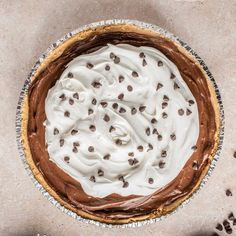 a chocolate pie with white frosting and chocolate chips on the top is shown from above