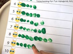 a child's hand is pointing at the number line on a sheet of paper