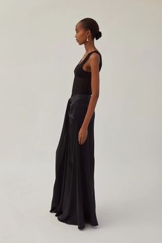 Heirlome's Leticia Skirt is a floor-length skirt with front tucked draped detail in silk crepe-back satin. Details include a center front godet and zipper for closure. Lined in lightweight silk. Product Details Designer ID: HL-IV-0613 Color: Black Composition: Self: 100% Silk; Lining: 100% Silk Imported Matching Separates, Front Tuck, Fashion Institute, Black Tank Dress, Floor Length Skirt, Jumpsuit Jacket, Neon Purple, Engineered Garments, Silk Crepe