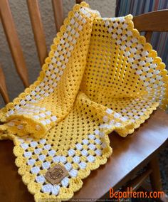 a crocheted blanket sitting on top of a wooden chair