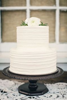 a white wedding cake sitting on top of a table