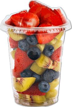 a plastic container filled with fruit on top of a white table