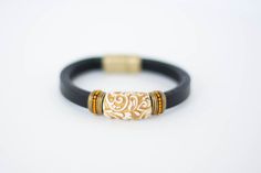 This Regal Leather Bracelet is fit for a queen—or anyone with a sense of style. The dazzling gold and ivory swirled bead is set off on a flat black leather, making it a perfectly elegant accessory. Plus, the magnetic clasp makes it easy to put on ... Royal Entrance, The Dazzling, Leather Making, Murano Glass Beads, Bridal Bracelet, Elegant Accessories, Bridal Necklace, Magnetic Clasp, Black Flats