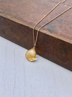 Yellow Topaz Necklace, November Birthstone, Yellow Topaz Teardrop Pendant, Solid 14k Gold, Real Gold Jewelry, Minimal Layering, Gift for her This beautiful dainty necklace features a flawless quality 8 mm micro faceted yellow topaz chubby teardrop wire wrapped in Solid 14k yellow gold. The yellow topaz pendant is suspended from a dainty solid 14k yellow gold chain. This is an everyday necklace, perfect for a gift for a girl born in November, as this is their birthstone. All element in this neckl Gold Drop Birthstone Necklace With Gemstone, Teardrop Topaz Yellow Gold Jewelry, Elegant Yellow Topaz Jewelry, Teardrop Topaz Necklace For Gift, Yellow Gold Topaz Teardrop Jewelry, Yellow Gold Briolette Gemstone Drop Necklace, Dainty Yellow Pendant Jewelry, Teardrop Citrine Gemstone Necklace, Yellow Topaz Necklace For Gift