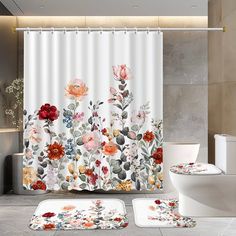 a bathroom with flowers on the shower curtain, rugs and toiletries in it