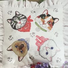 a white pillow with cats and kittens on it