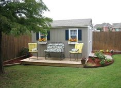 a small backyard with lawn furniture and flowers