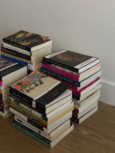 a stack of books sitting on top of a wooden floor