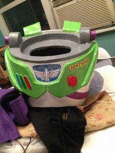 there is a toy that looks like the buzz lightyear seat on top of a bed