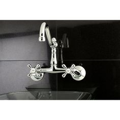 the faucet is attached to the wall above the sink in this black and white bathroom