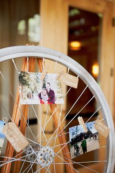 a wheel with pictures attached to it and some other things hanging from the spokes